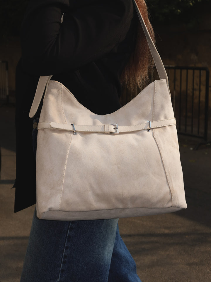 Beige belted slouch shoulder bag faux suede – held by model (1)