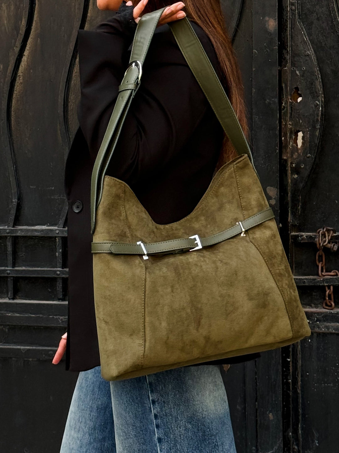 Olive belted slouch shoulder bag faux suede – held by model (1)