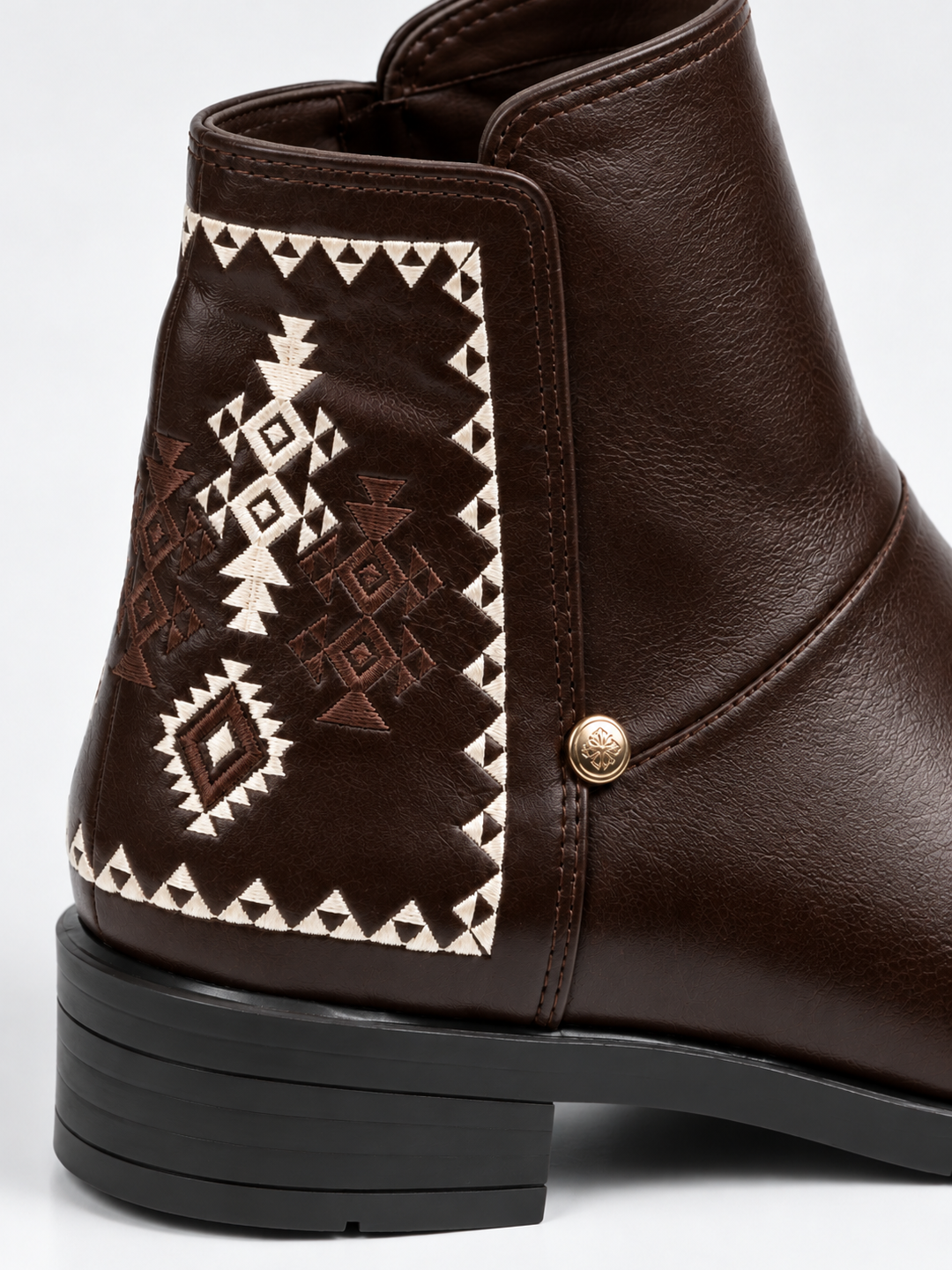 Brown embroidered panel ankle boot faux leather – embroidered panel and stud close-up