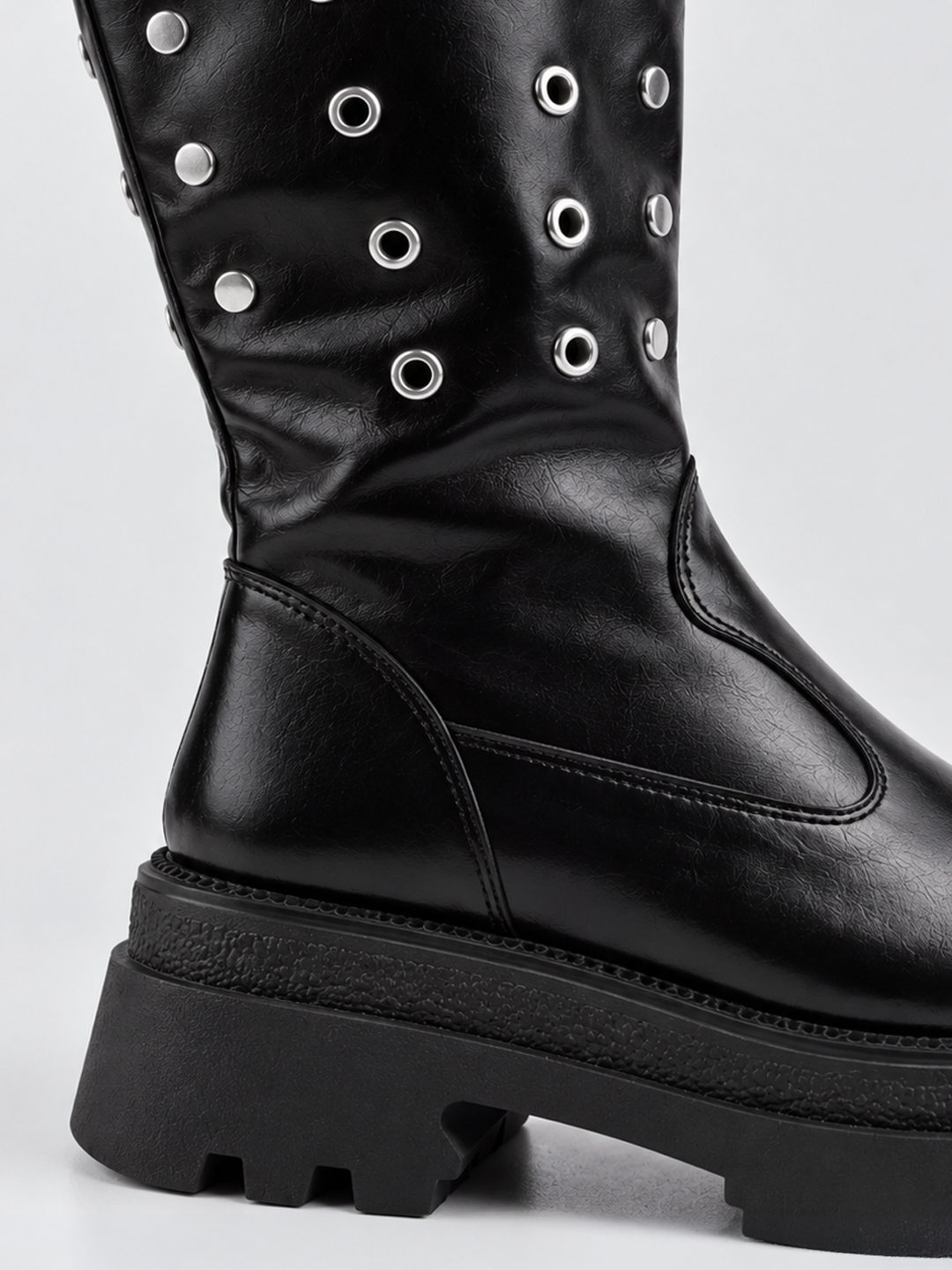 Black faux leather eyelet platform mid-calf boot – back heel and lug sole close-up