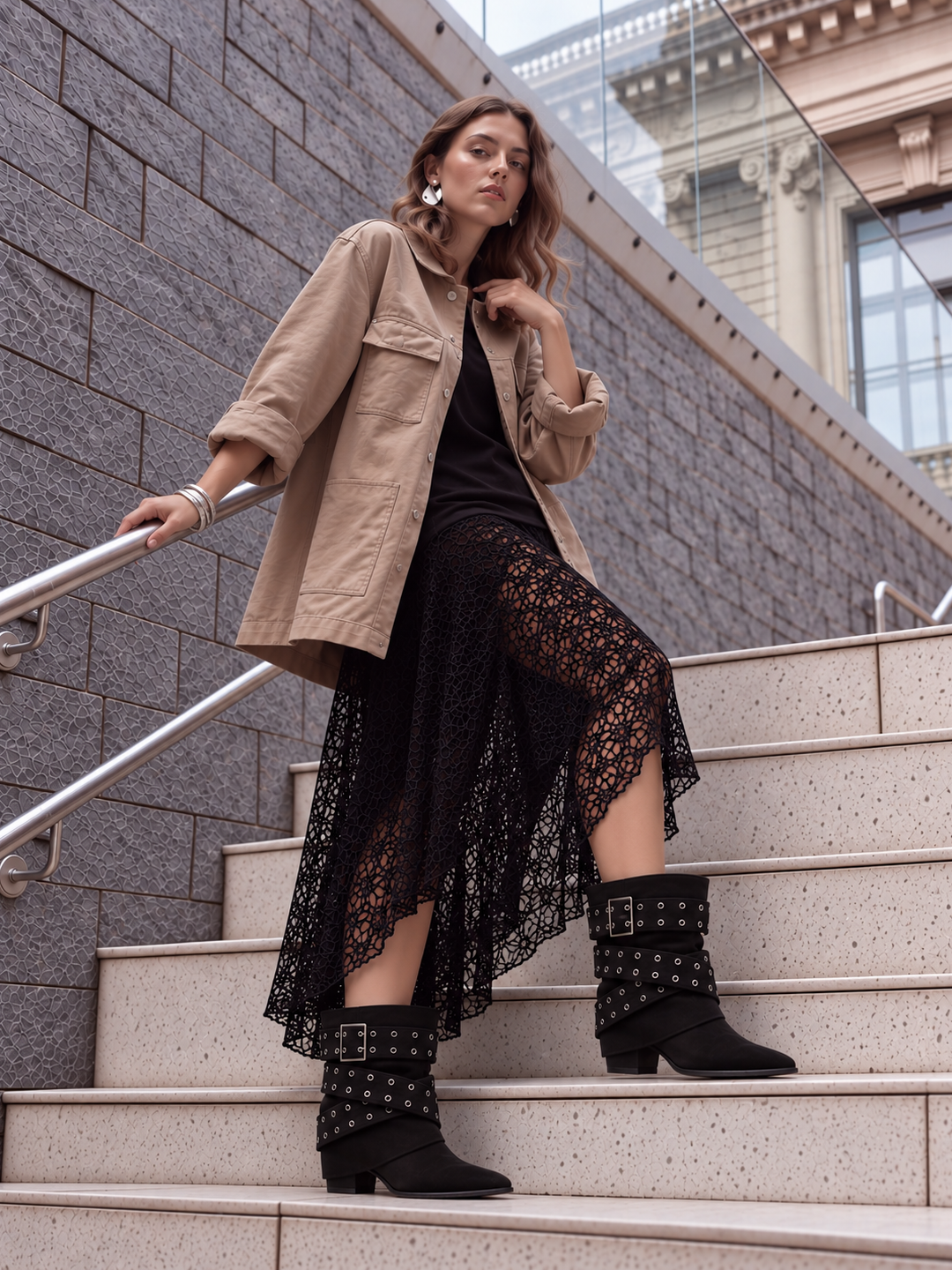 Black faux suede buckle strap slouch ankle boot – full outfit on model on city steps