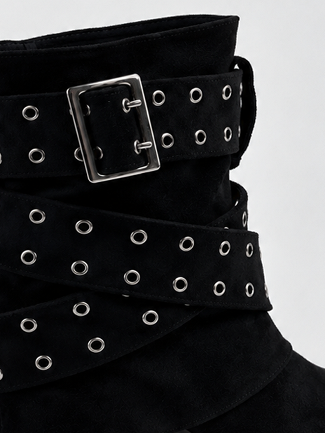 Black faux suede buckle strap slouch ankle boot – wrapped eyelet strap detail