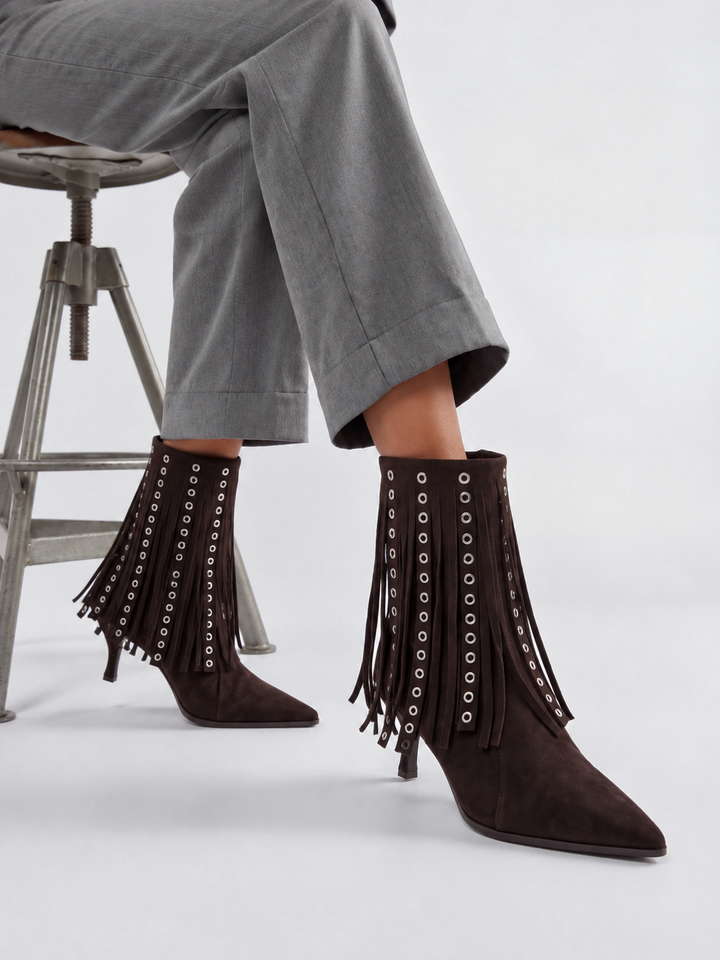 Brown faux suede fringe heeled ankle boot – worn on model, seated, front view