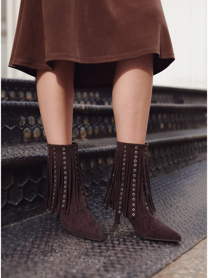 Brown faux suede fringe heeled ankle boot – worn on model on steps, front close-up