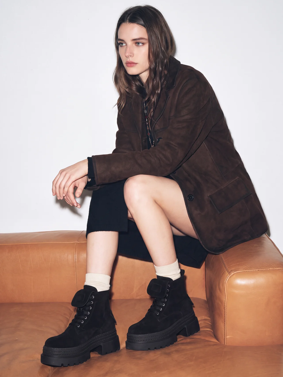 Black pocket lace-up platform ankle boot faux suede – worn on model, seated on a sofa