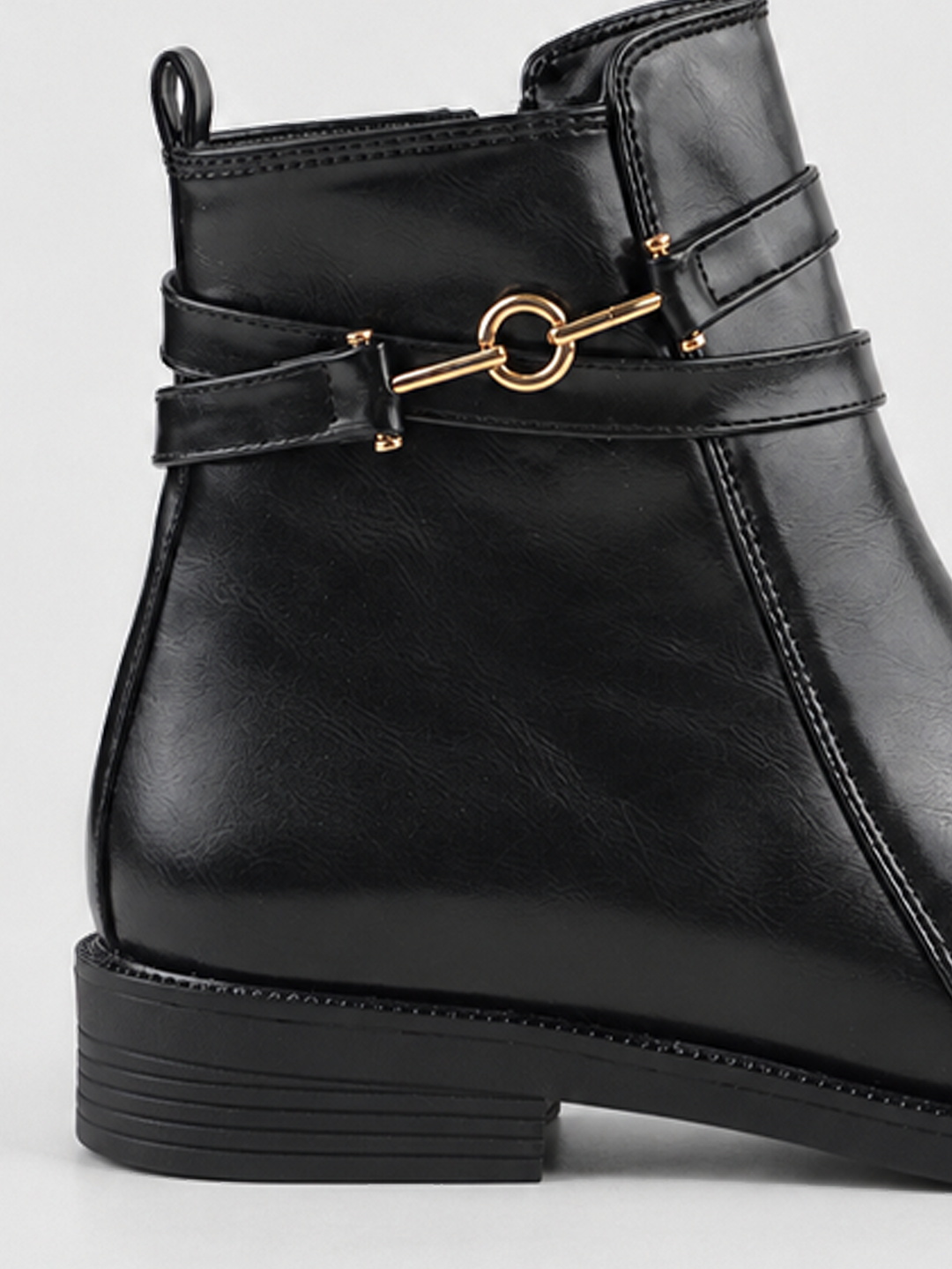 Black horsebit strap ankle boot faux leather – horsebit strap and heel close-up