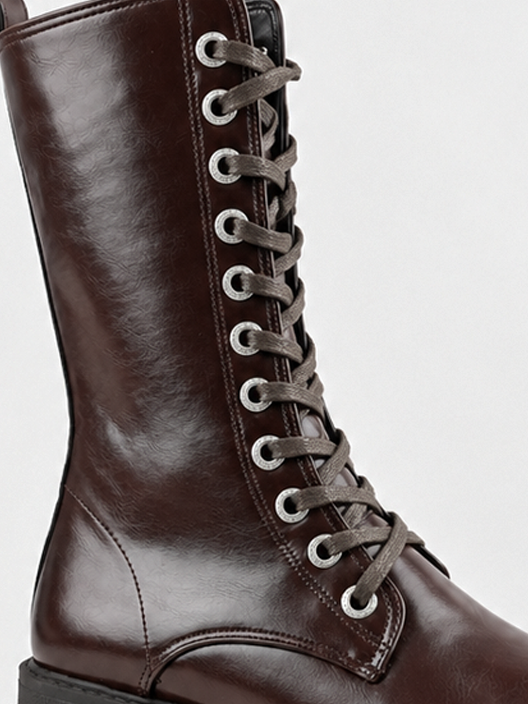 Brown mid-calf lace-up combat boot faux leather – laces and eyelets close-up