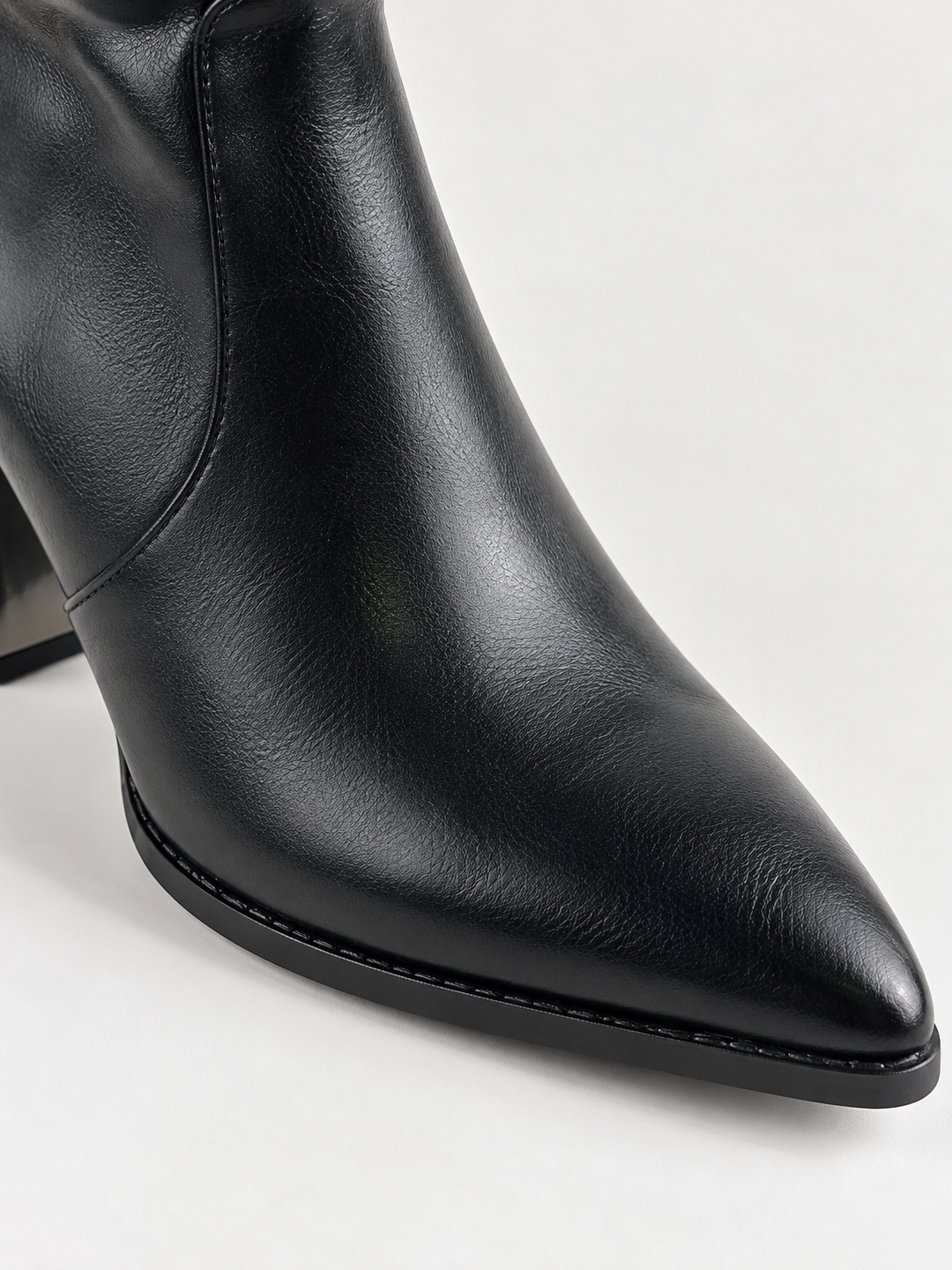 Black slouchy metal-trim block heel ankle boot faux leather – pointed toe close-up