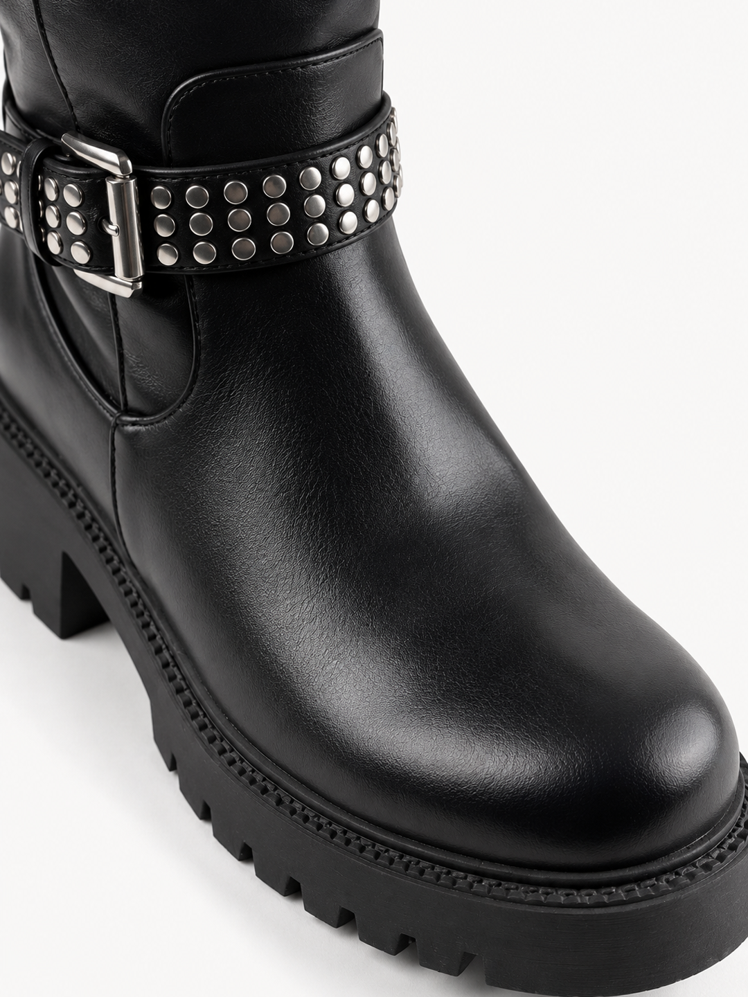 Black studded strap knee-high riding boot faux leather – round toe and lug sole close-up