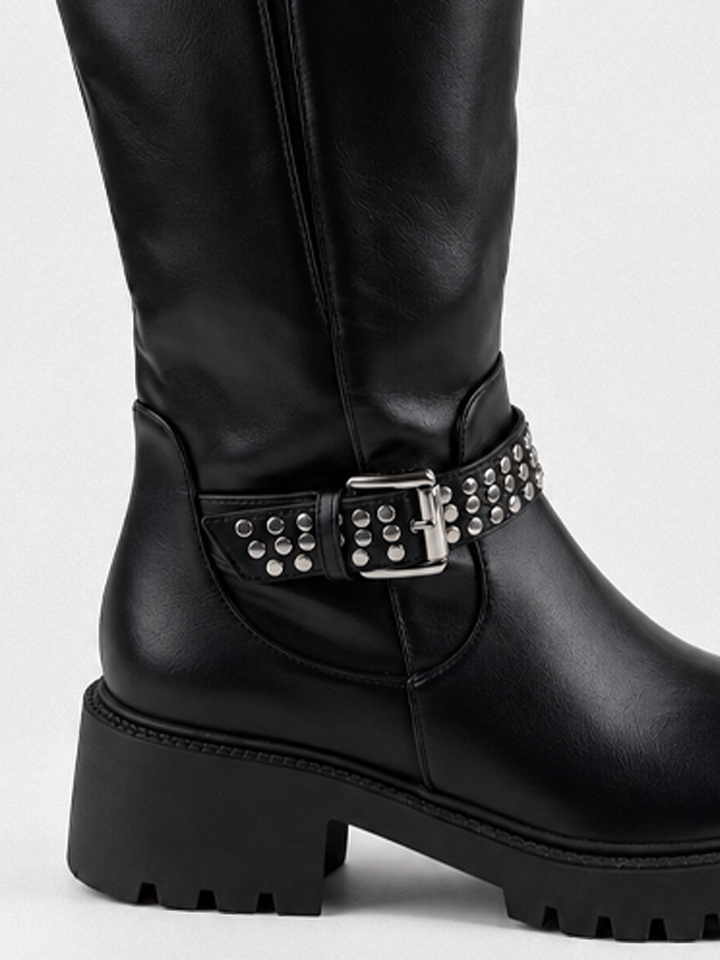 Black studded strap knee-high riding boot faux leather – studded ankle strap and heel close-up