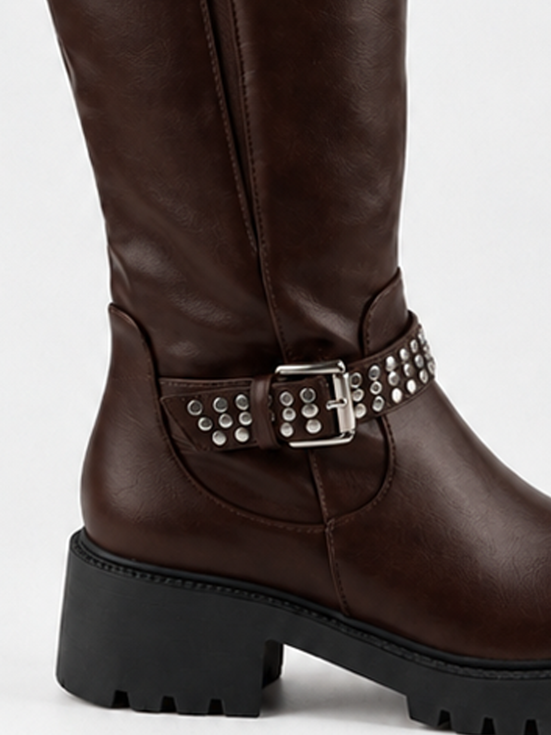Brown studded strap knee-high riding boot faux leather – studded ankle strap and heel close-up